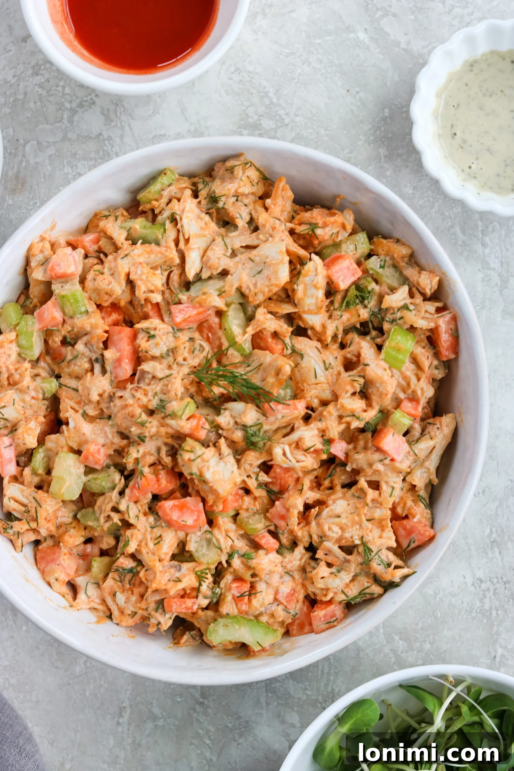 Healthy Buffalo Ranch Chicken Salad in a bowl with fresh ingredients