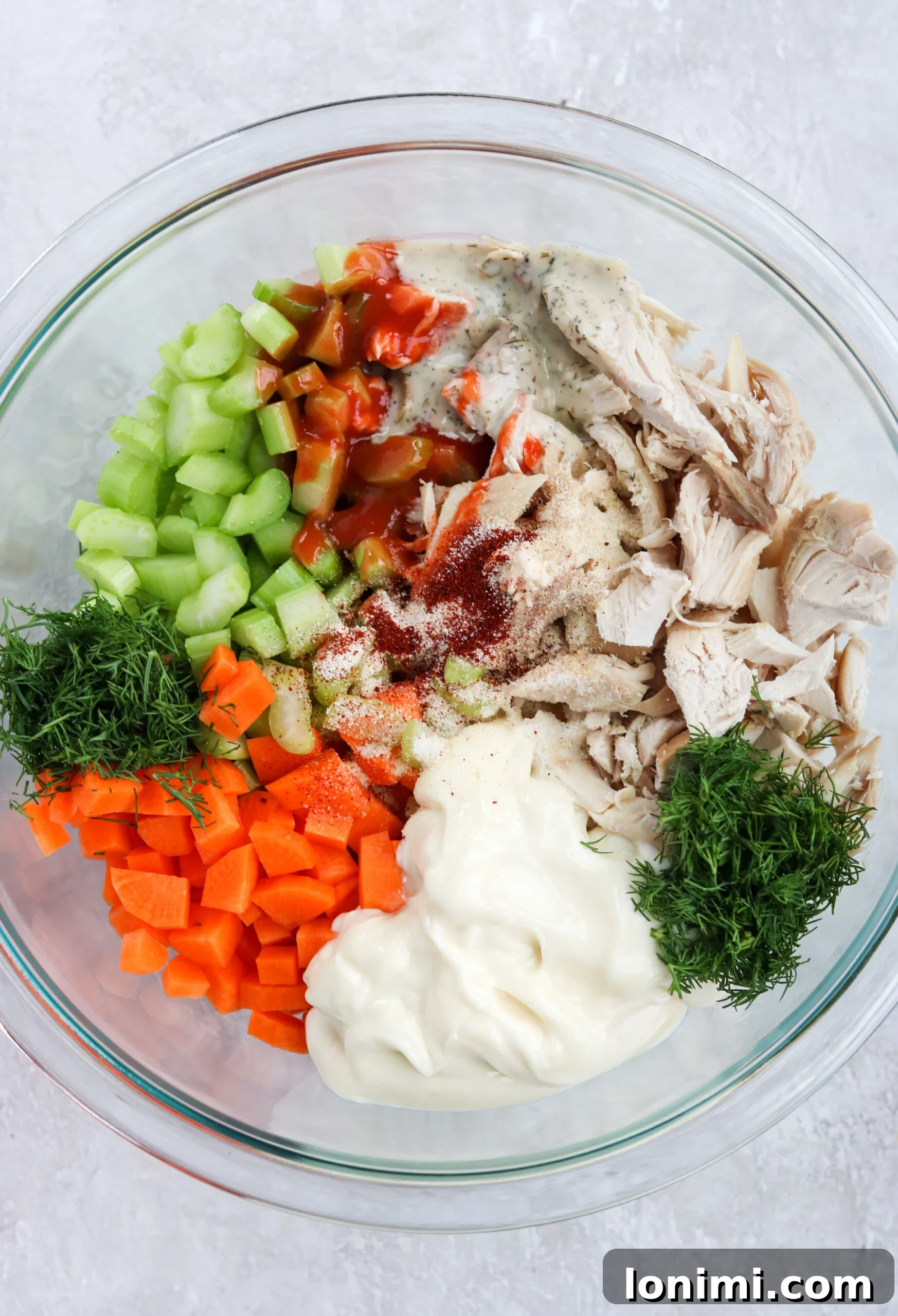 Ingredients for Buffalo Ranch Chicken Salad being mixed
