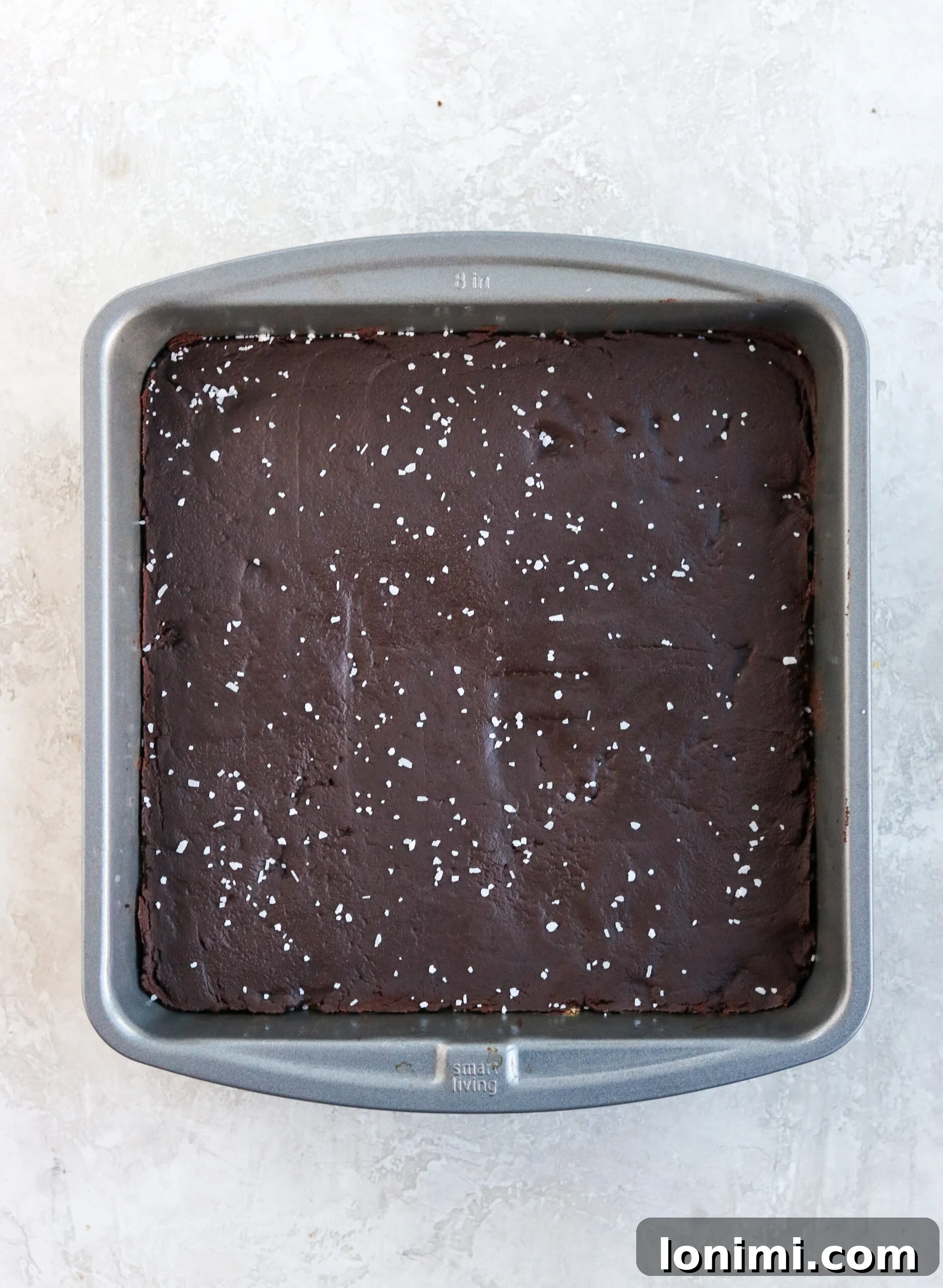 Finished vegan millionaire shortbread bars in a 8x8 pan with sea salt