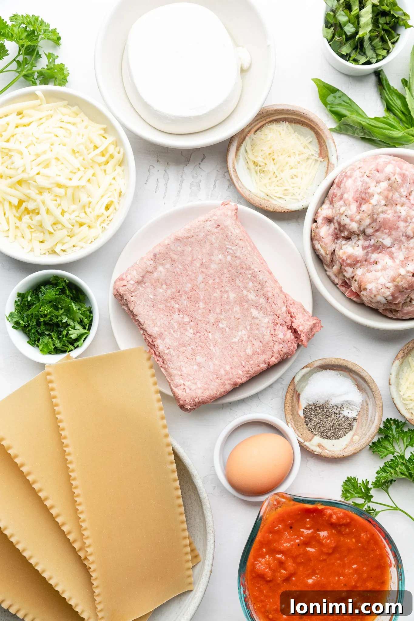 Effortless Allergen-Friendly Lasagna 3 Ingredients for gluten-free lasagna: gluten-free noodles, various cheeses, fresh parsley, marinara sauce, ground beef, Italian sausage, and an egg