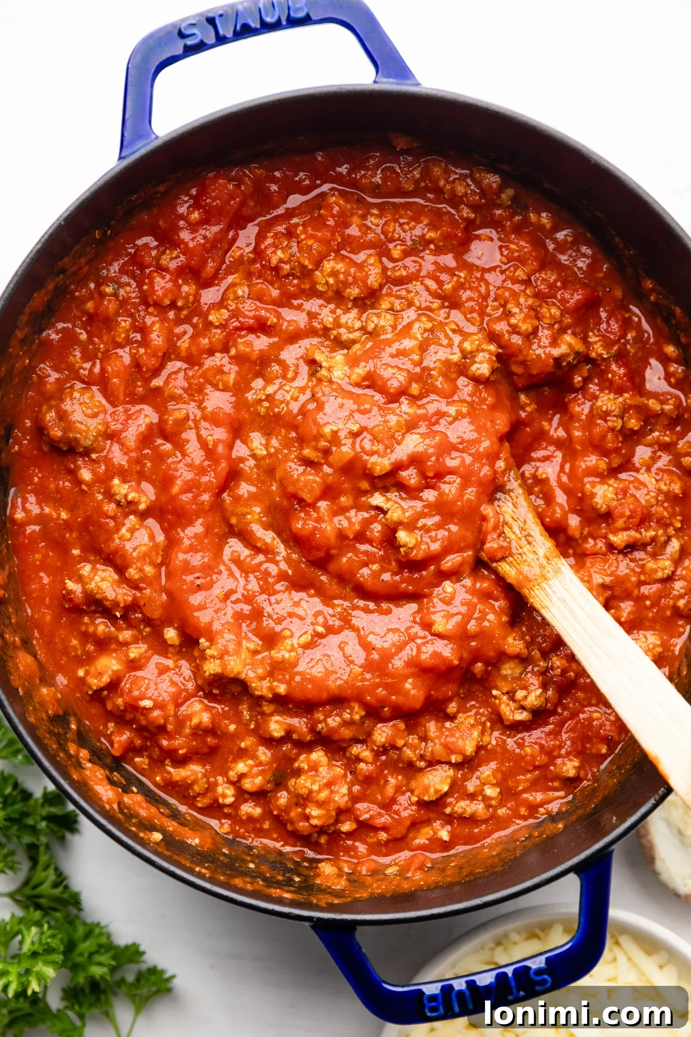 Effortless Allergen-Friendly Lasagna 4 Rich meat sauce simmering in a blue Staub Dutch oven, ready for the lasagna