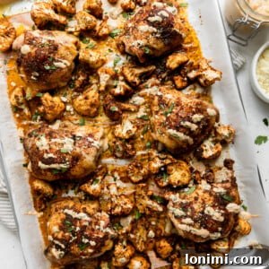 Sheet Pan Fiesta Bowls with Chicken and Roasted Cauliflower 8 a silver sheet pan with roasted cauliflower and chicken thighs