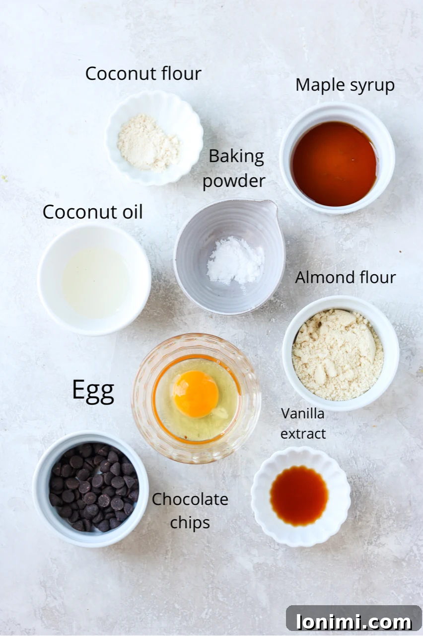Various gluten-free mug cake ingredients displayed in small bowls and clearly labeled for easy identification.