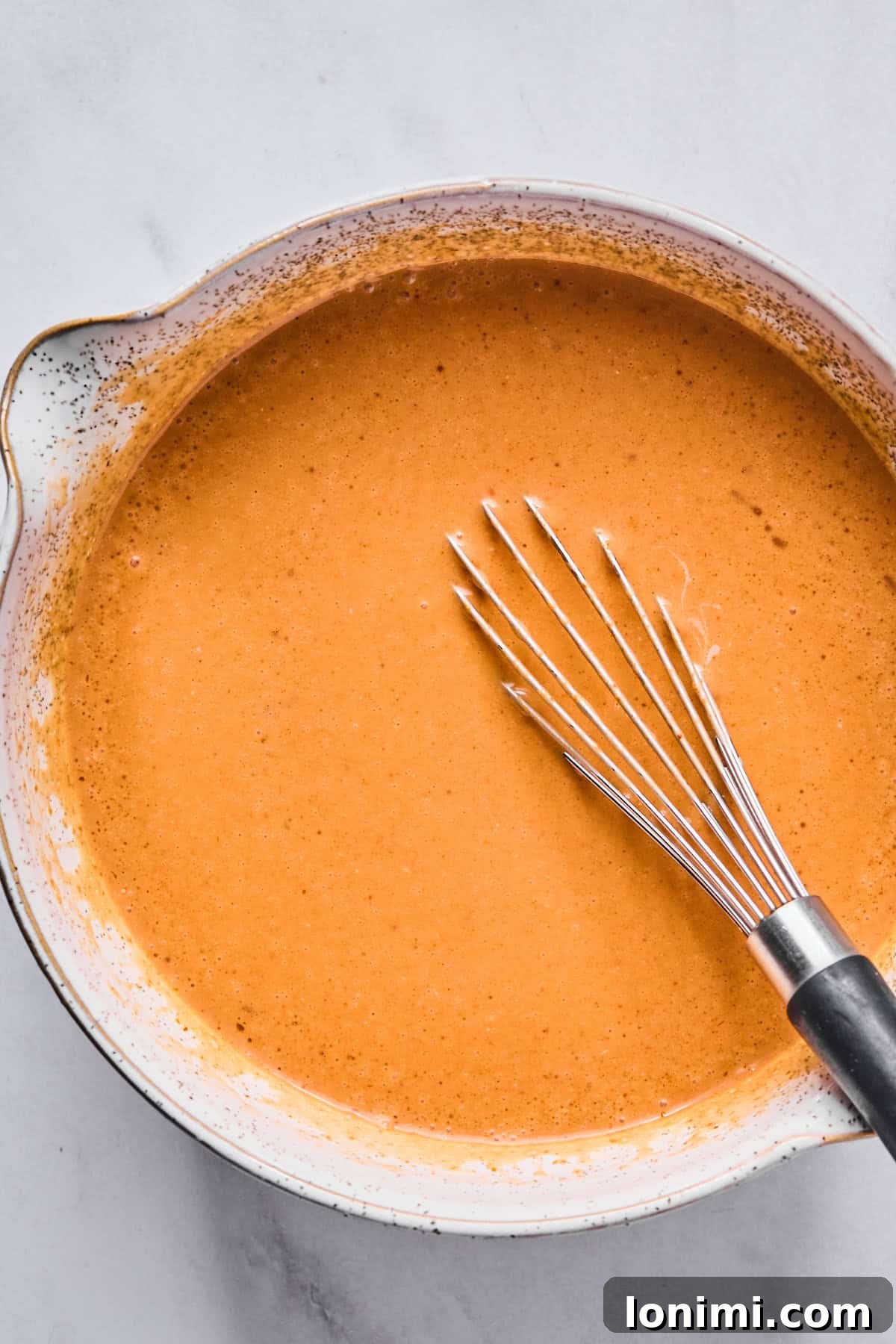Thai sauce in a bowl with a whisk