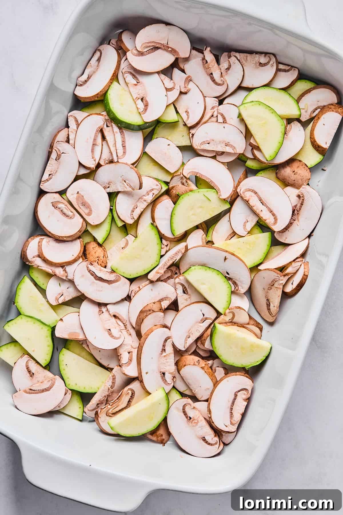 mushrooms and zucchini in a casserole dish