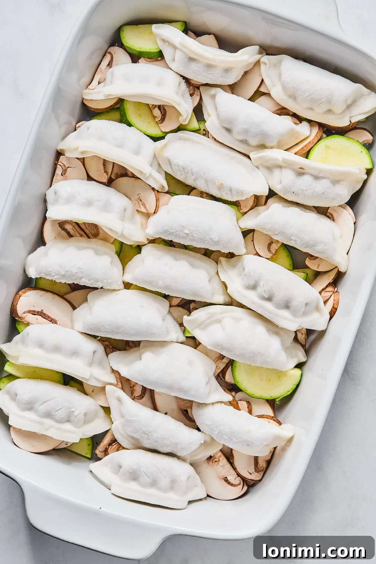 dumplings on top of vegetables in a dish