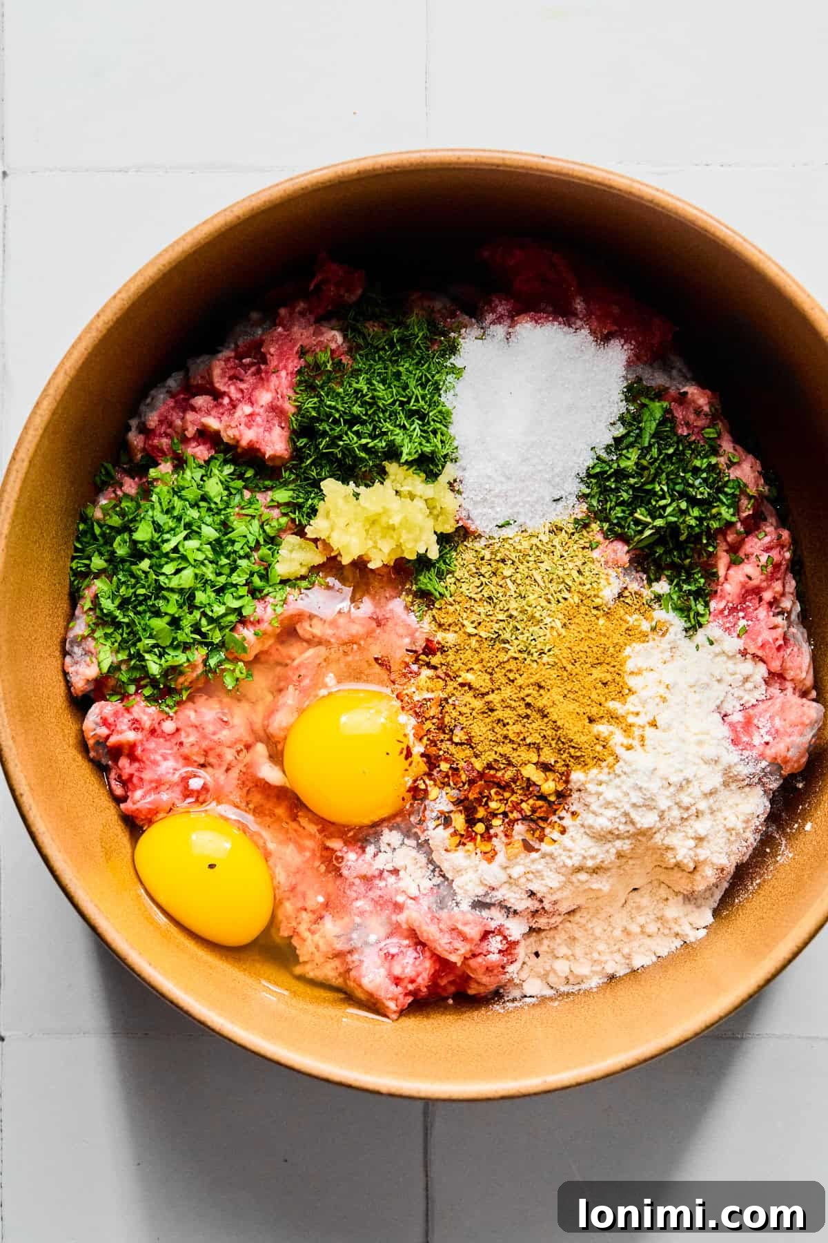 Easy Greek Lamb Meatballs with Zesty Lemon Dill Yogurt 4 Greek lamb meatball ingredients in a large bowl.