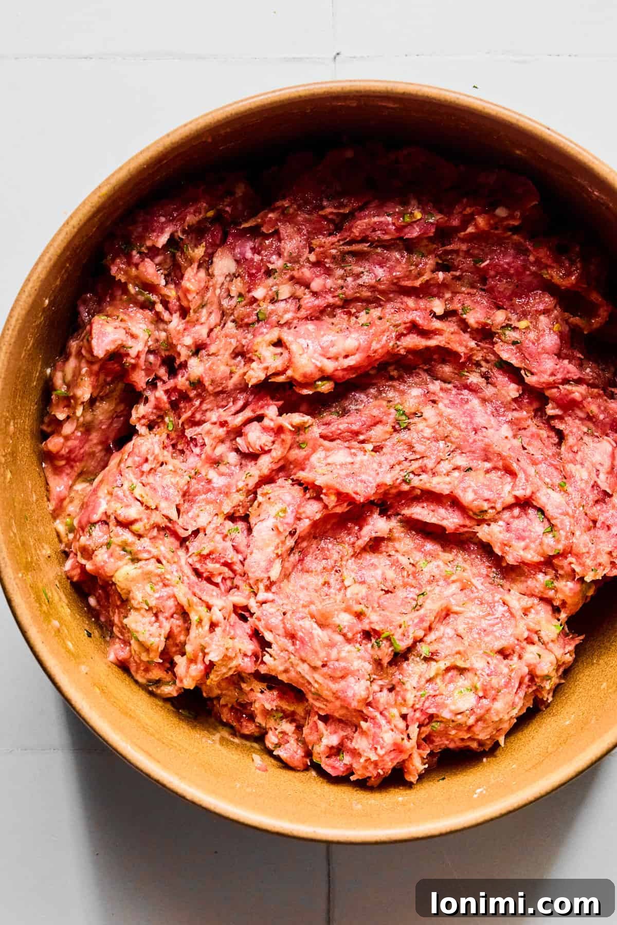 Easy Greek Lamb Meatballs with Zesty Lemon Dill Yogurt 5 Meatball ingredients in a large bowl mixed together so that everything is evenly incorporated.