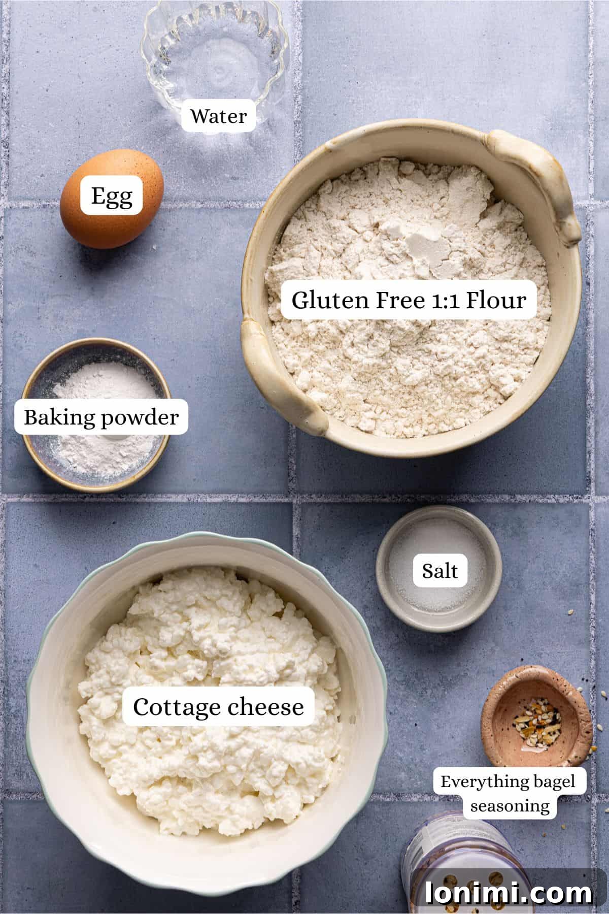 Cottage cheese bagels recipe ingredients laid out in nesting bowls and labeled. 