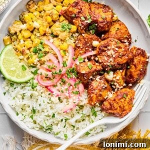 Street corn chicken and rice bowls with a yellow napkin and a fork in the bowl