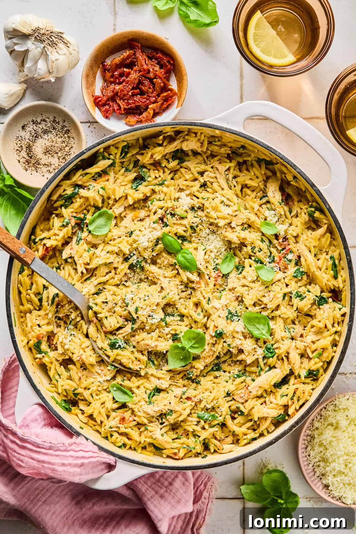 Irresistible Gluten Free Marry Me Chicken Orzo 8 One-pan marry me chicken orzo in a skillet with ingredients arranged around the pan.
