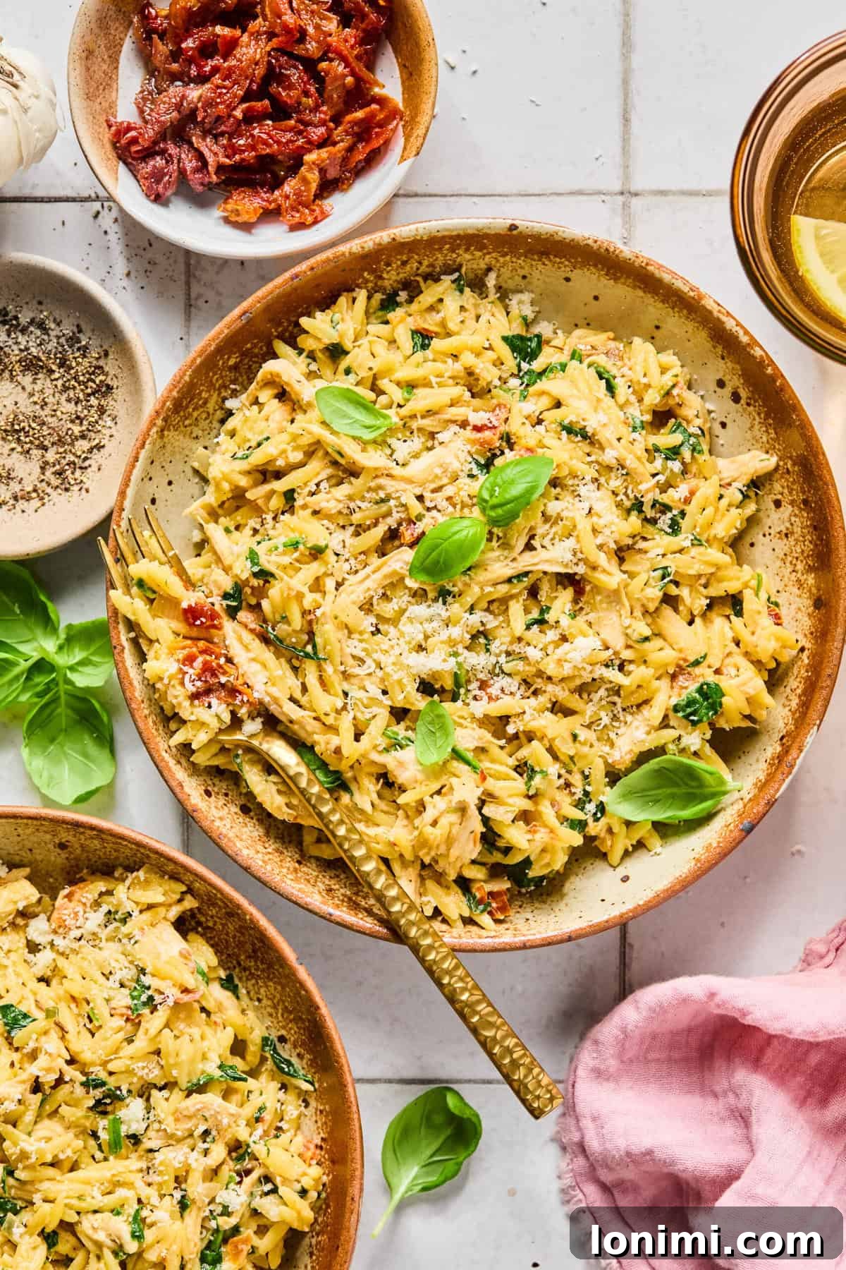 Irresistible Gluten Free Marry Me Chicken Orzo 9 Birds eye view of creamy gluten-free marry me chicken orzo topped with fresh basil and grated parmesan in a bowl.
