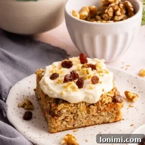 carrot cake baked oats with cream cheese frosting on a plate