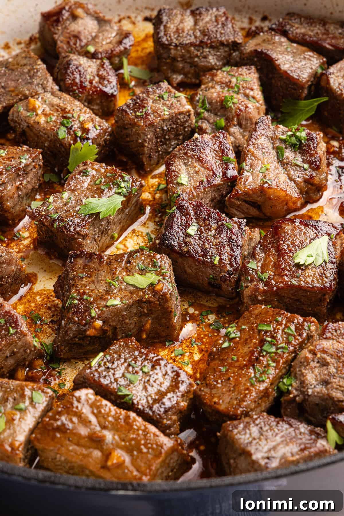 garlic butter steak bites close up in a pan