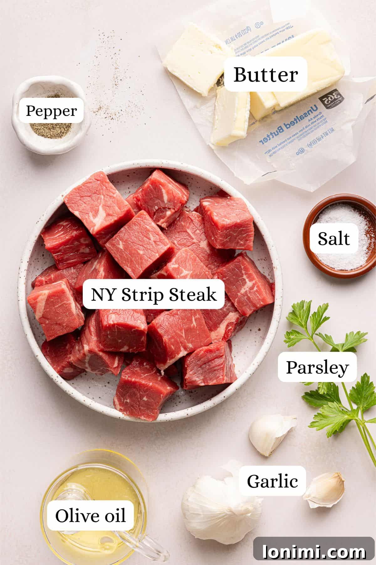 ingredients for garlic butter steak bites in nesting bowls