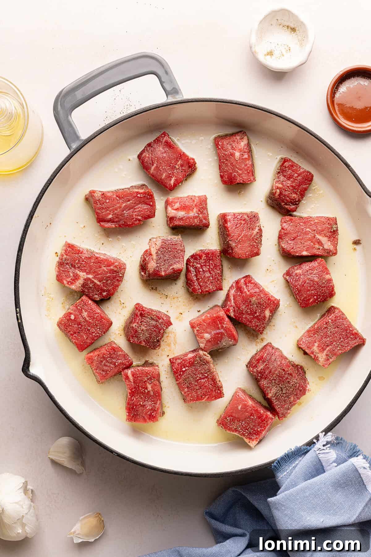 steak bites searing in a pan