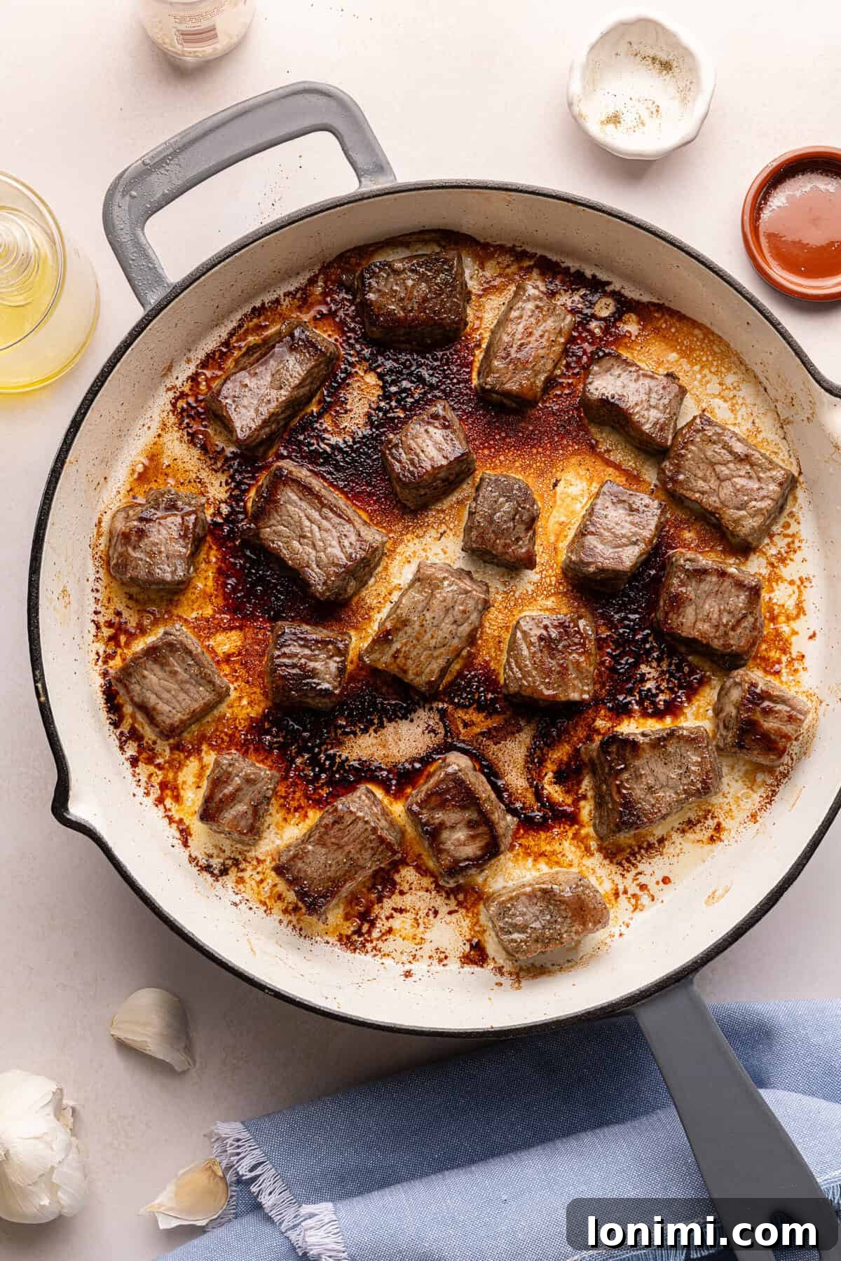 steak bites searing in a pan