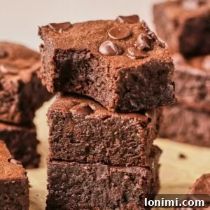 protein brownies stacked up on parchment paper