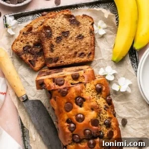protein banana bread with chocolate chips on a parchment lined baking sheet
