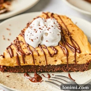 peanut butter pie with chocolate crust and whipped cream on a plate
