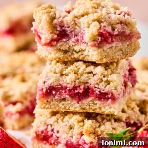 strawberry rhubarb crumble bars stacked on top of each other
