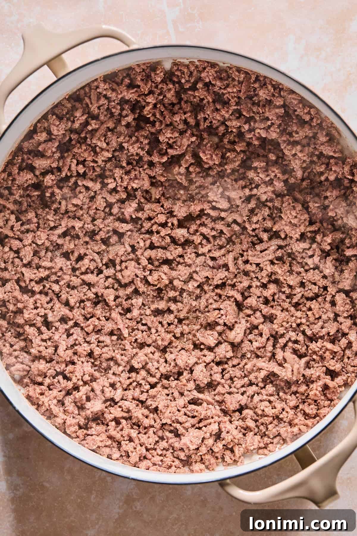 Browning ground beef in a Dutch Oven with olive oil, creating a rich base for the soup.
