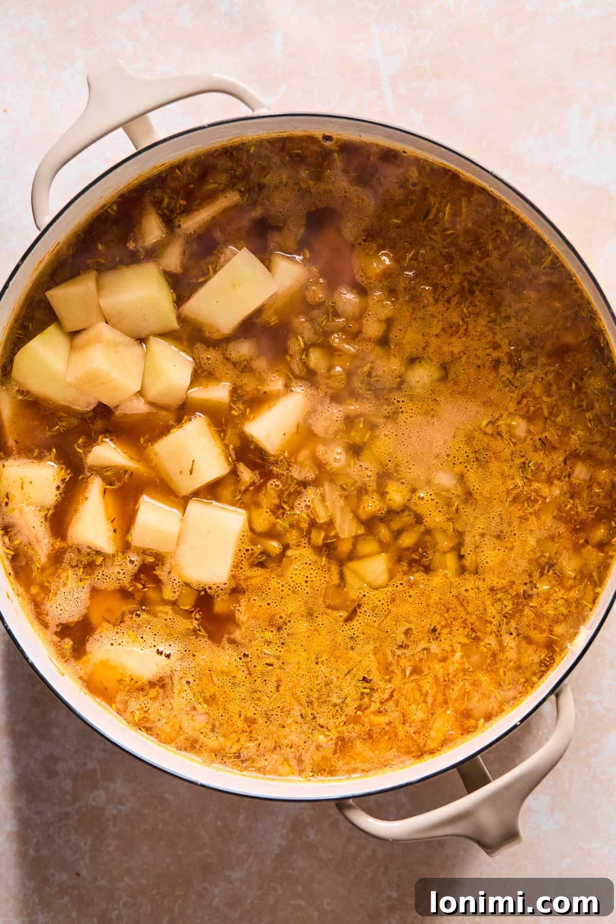 Dutch Oven with soup ingredients simmering until potatoes are perfectly tender.