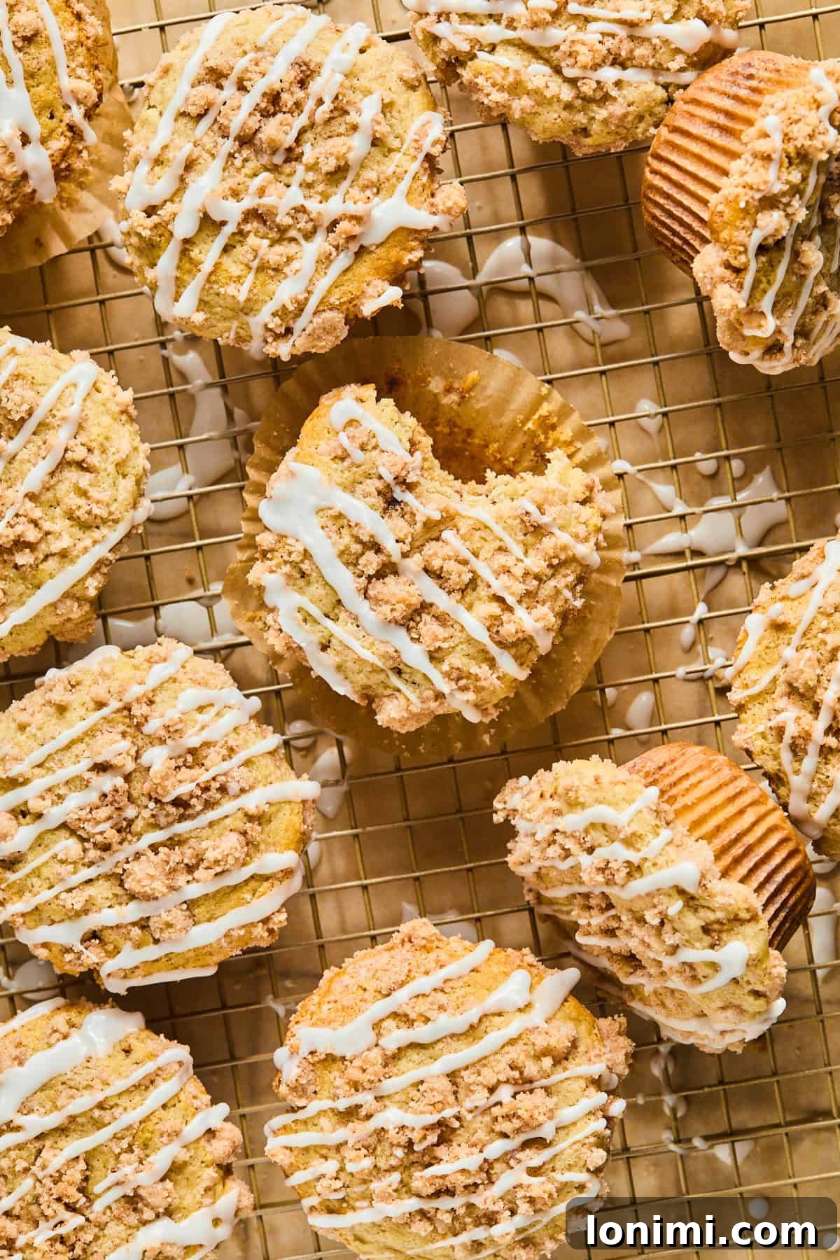 Gluten-Free Coffee Cake Crumble Muffins 7 Gluten-free coffee cake muffins arranged neatly on a cooling rack, showing their golden tops and crumbly streusel.