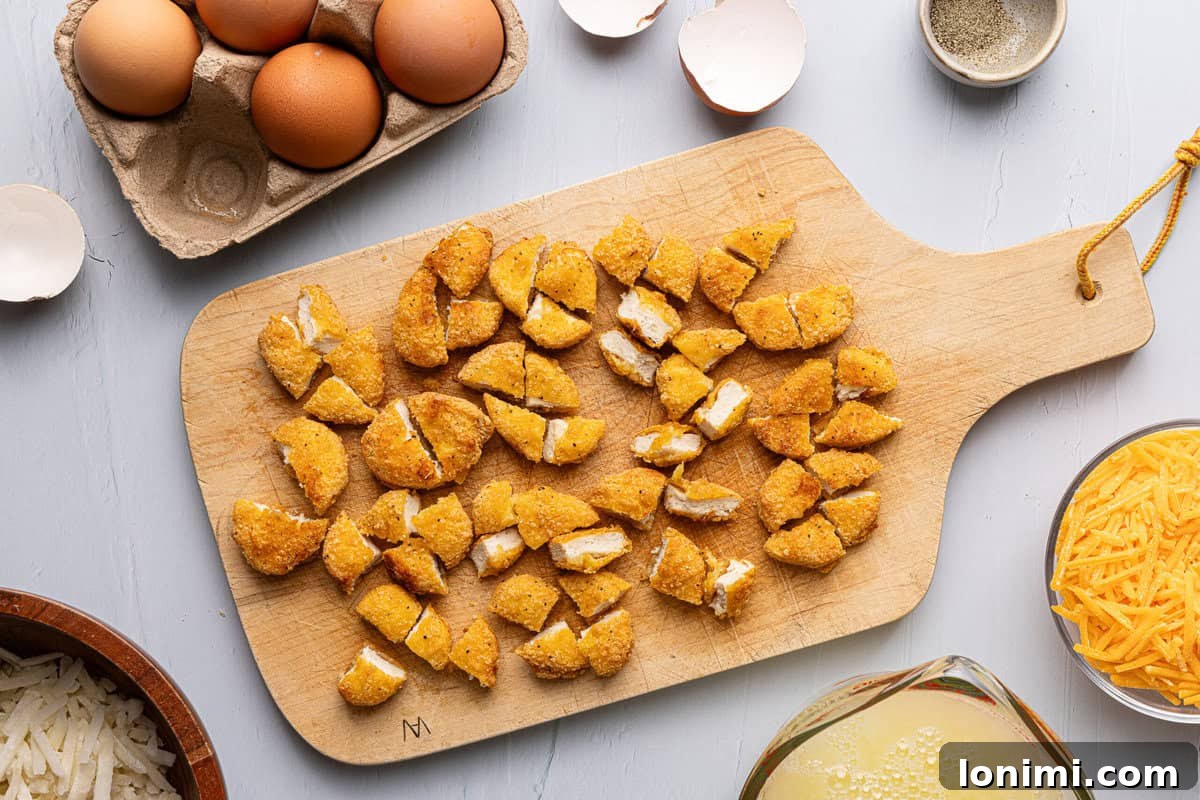Craft Your Own Chick-fil-A Hash Brown Scramble Bowls 4 chopped up chicken nuggets on a cutting board