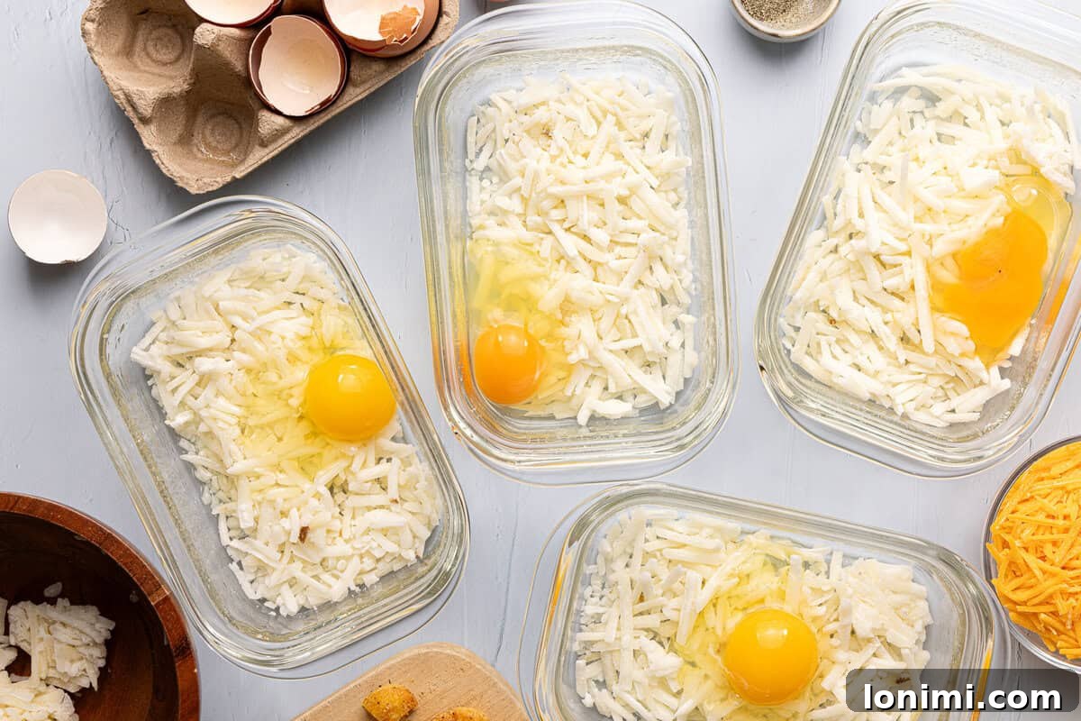 Craft Your Own Chick-fil-A Hash Brown Scramble Bowls 5 meal prep containers with hash browns and raw egg in each one
