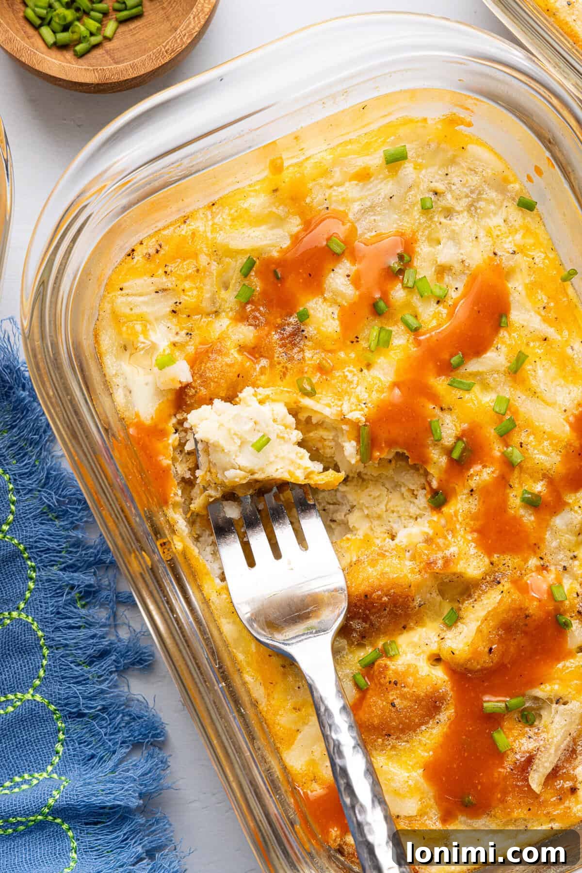 Craft Your Own Chick-fil-A Hash Brown Scramble Bowls 9 a close-up shot of a chick fil a copycat hash brown scramble bowl topped with hot sauce