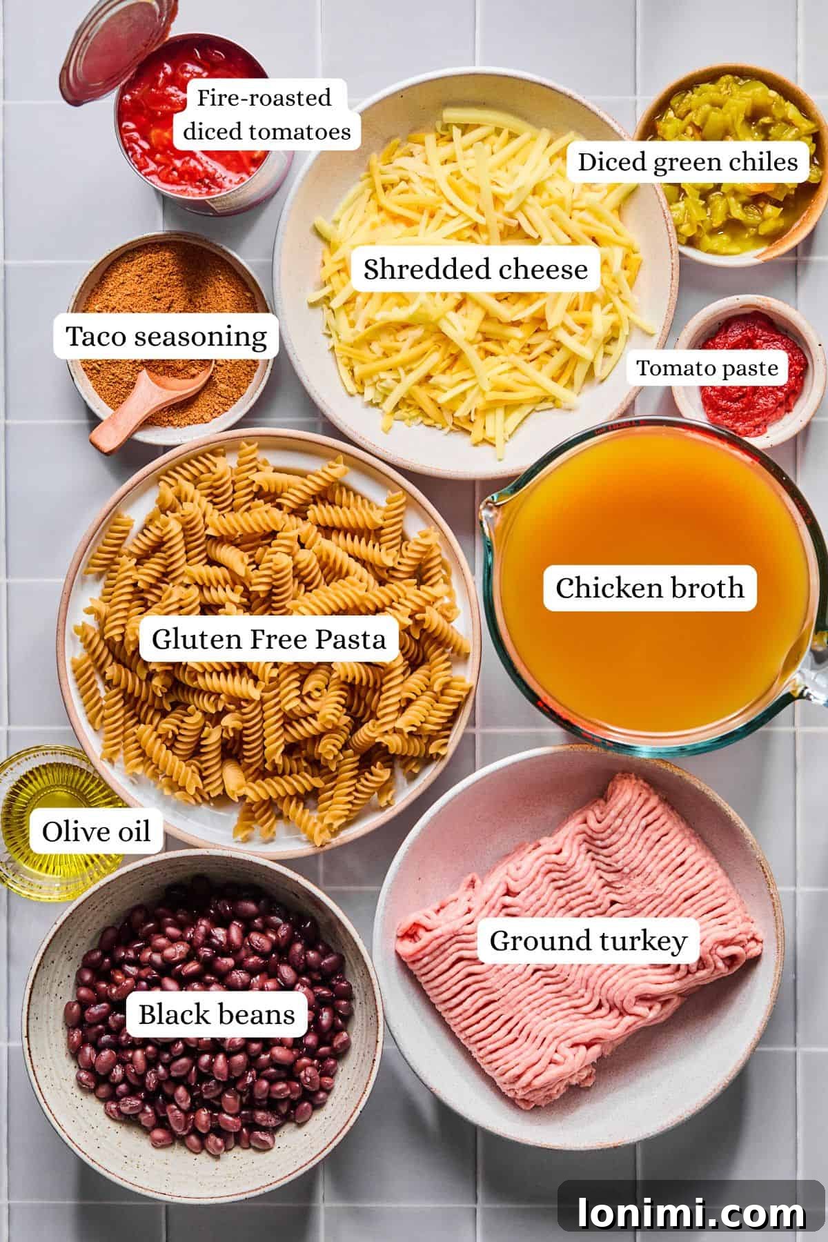 Easy Gluten-Free One Pot Taco Pasta 3 Ingredients for one pot taco pasta arranged in labeled nesting bowls.
