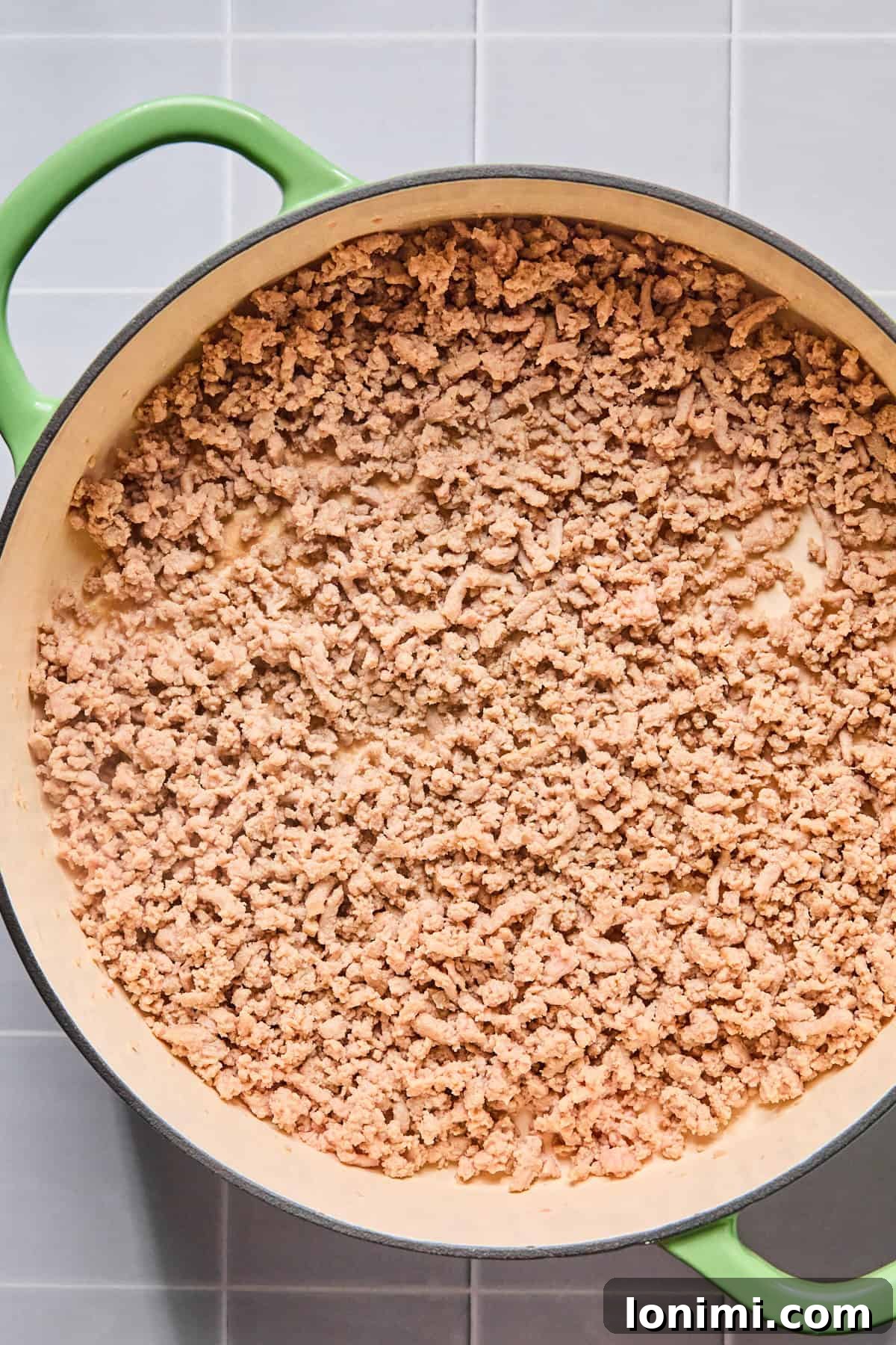 Easy Gluten-Free One Pot Taco Pasta 4 Ground turkey cooking in olive oil in a large skillet, broken up and browned.