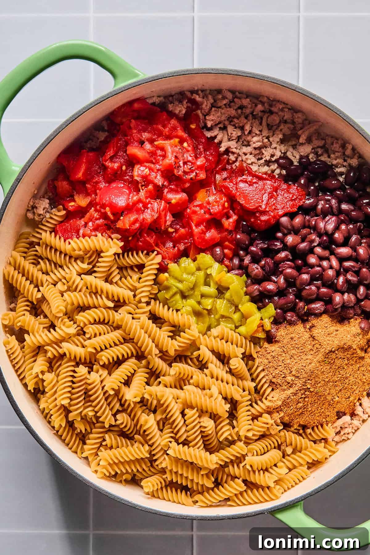 Easy Gluten-Free One Pot Taco Pasta 5 Taco seasoning, tomato paste, diced tomatoes, green chiles, black beans, and pasta in the skillet.