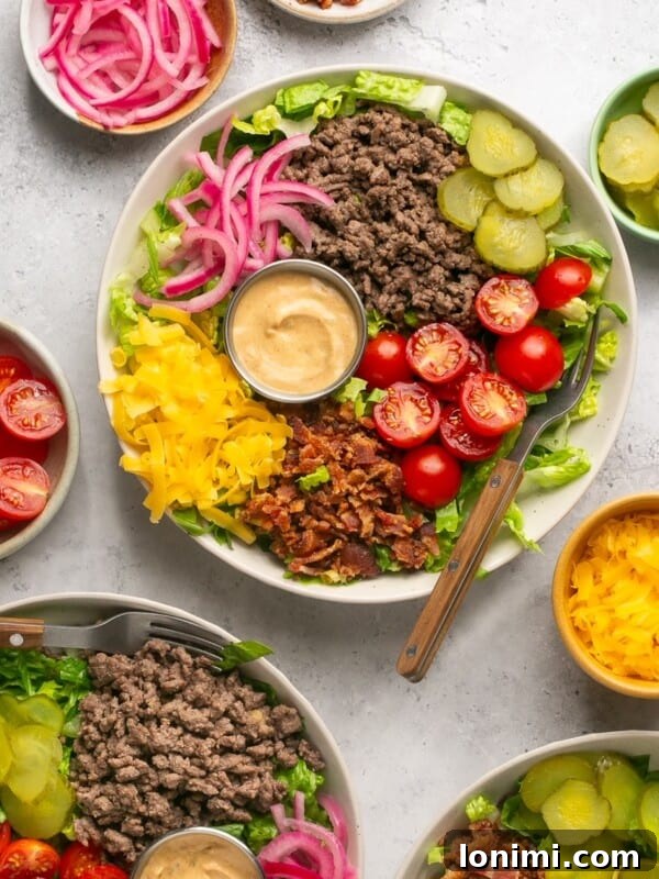 cheeseburger bowls with ground beef, veggies, pickled onions, and Big Mac Sauce surrounded by bowls of toppings