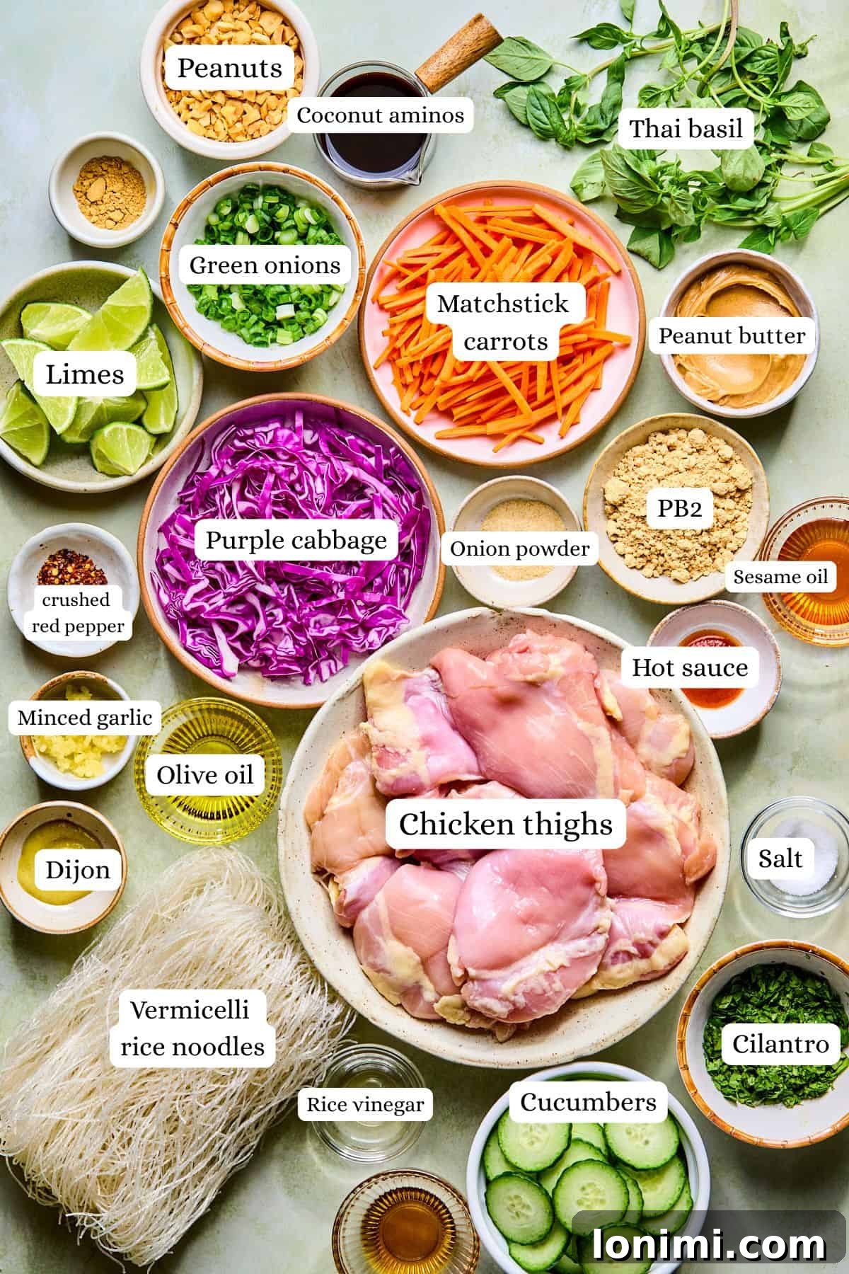Spring roll bowl recipe ingredients labeled and laid out in nesting bowls.