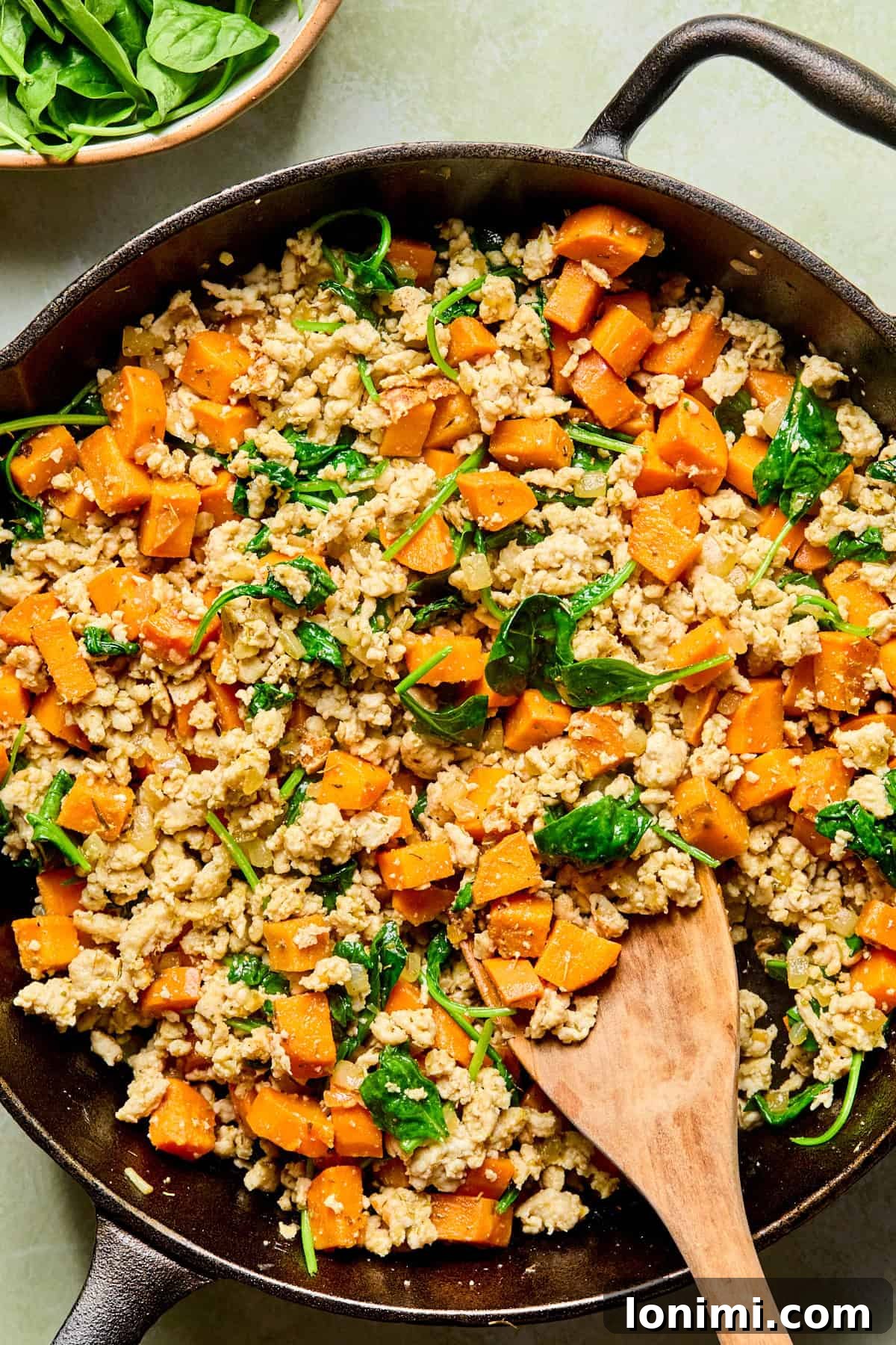 sweet potato turkey skillet with a wooden spoon