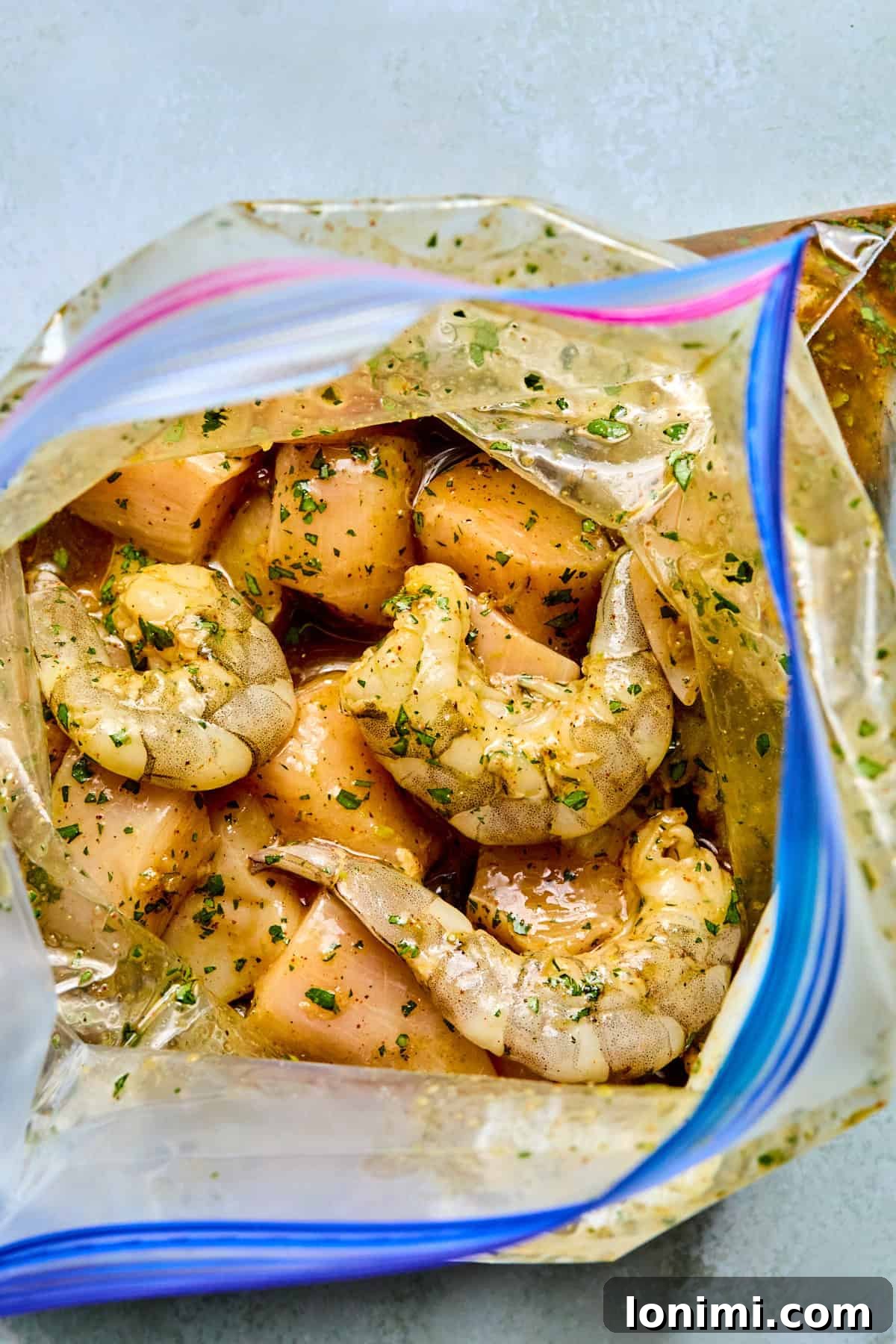 chicken and shrimp marinating in a plastic bag