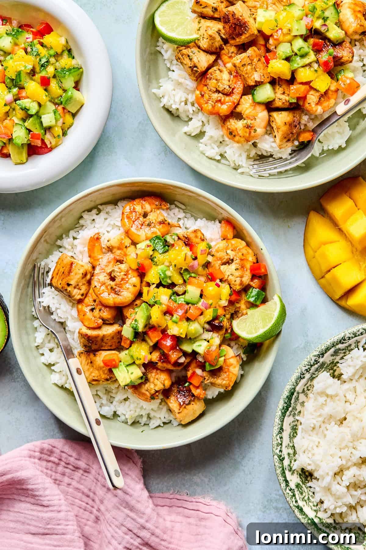 2 bowls of cilantro lime chicken and shrimp with rice and salsa