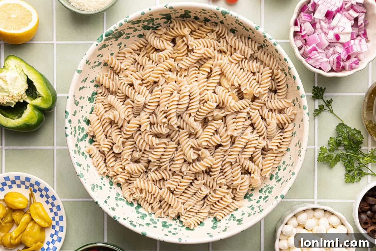 Gluten-Free Italian Pasta Salad Recipe for Delicious Summer Meals 5 Cooked gluten-free fusilli pasta rinsed with cold water, drained, and in large mixing bowl.
