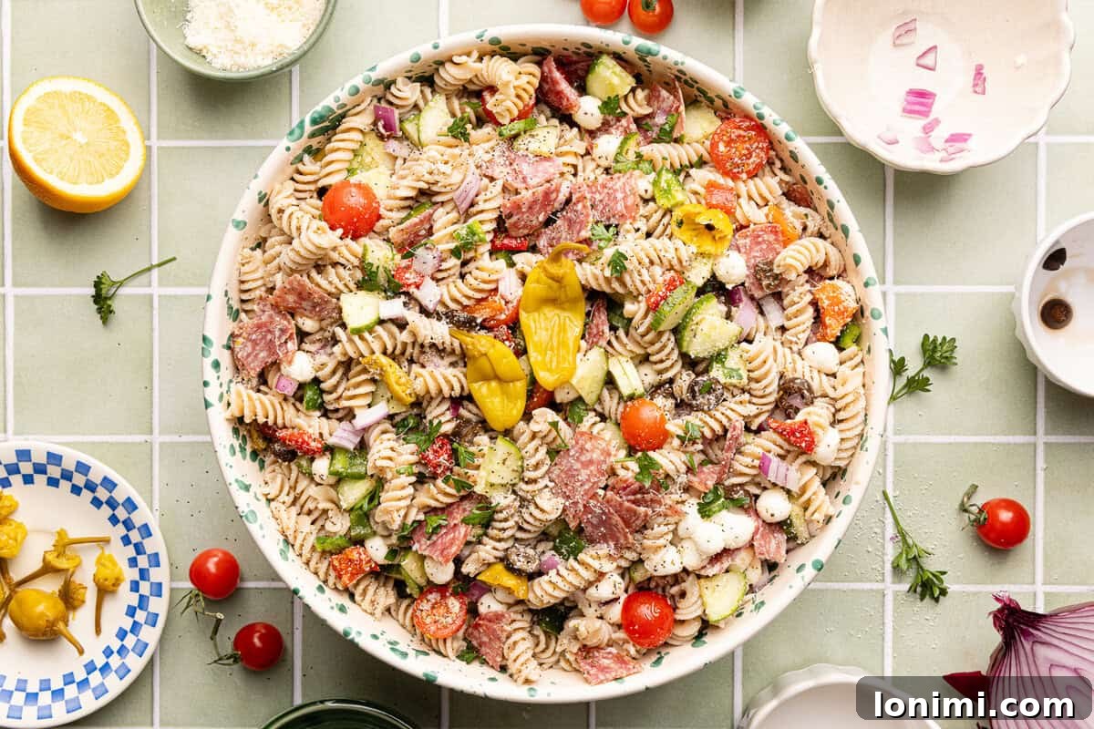 Gluten-Free Italian Pasta Salad Recipe for Delicious Summer Meals 6 Gluten free pasta salad assembled in a decorative serving bowl and topped with extra pepperoncinis.