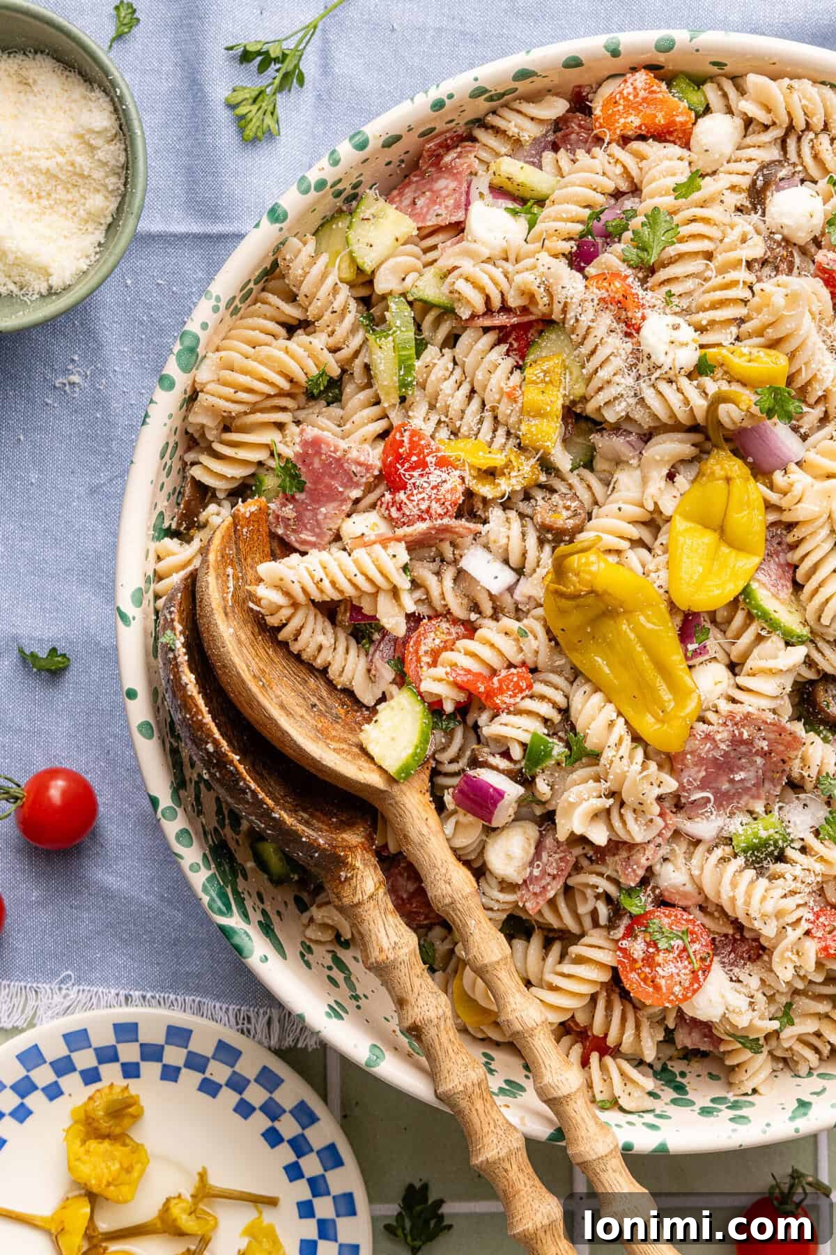 Gluten-Free Italian Pasta Salad Recipe for Delicious Summer Meals 7 Gluten free pasta salad served in a decorative bowl with wooden serving spoons ready for serving.