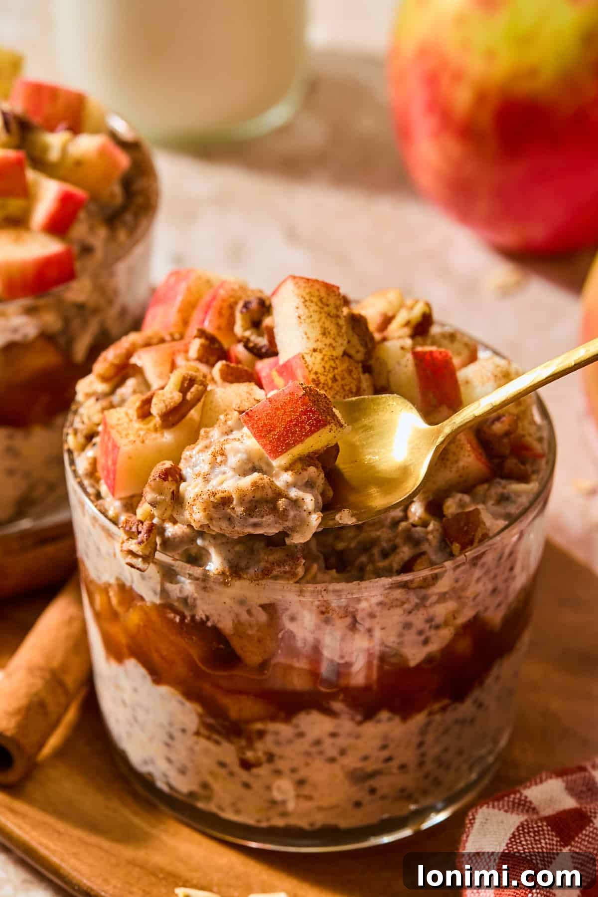 Apple Pie Protein Overnight Oats 9 apple pie overnight oats with a spoon taking a scoop out